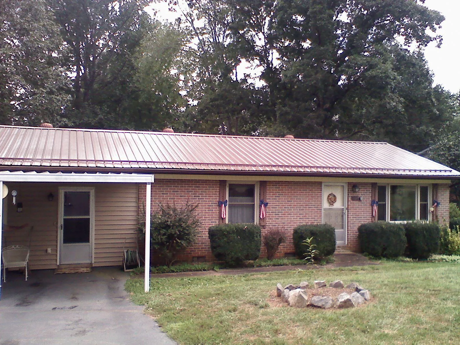 Bronze metal roof and carport on a brick ranch home — Roof Repair work by our crew in Creve Coeur