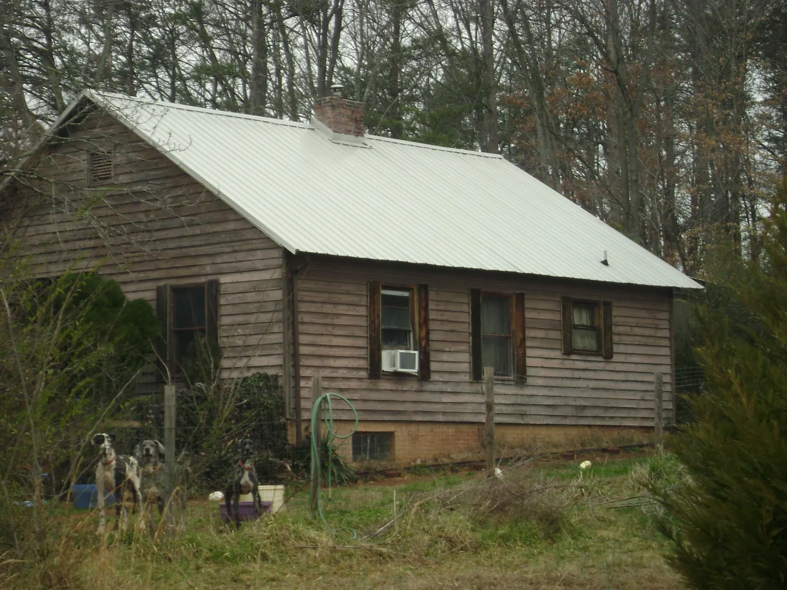 White metal roof on an old wood sided farmhouse, from a Metal Roof Installation job in Creve Coeur